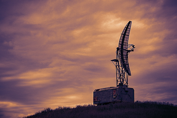 Old radar antenna in field